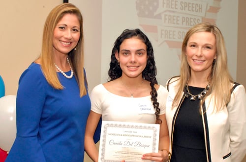 Attorney presents award certificate to smiling young client alongside her mother in the office.