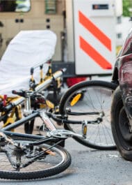 Bicycle accident scene with damaged bikes near truck, representing potential personal injury case