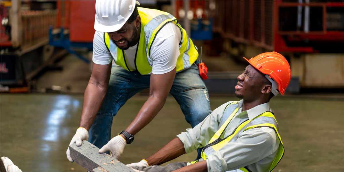 Warehouse workers discussing safety hazards. Attorneys help if you're injured on the job.