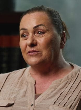 Concerned elderly woman with wrinkled face looking worried, in need of legal assistance or advice