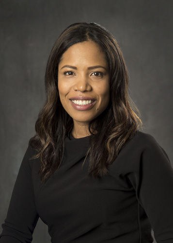 Smiling professional female attorney headshot against gray background - Atlanta injury lawyer