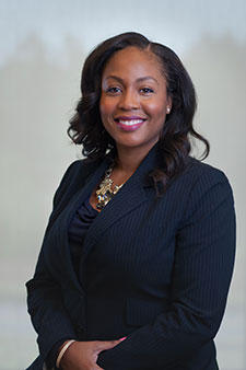 Smiling African American female attorney in professional attire, ready to assist with legal needs.