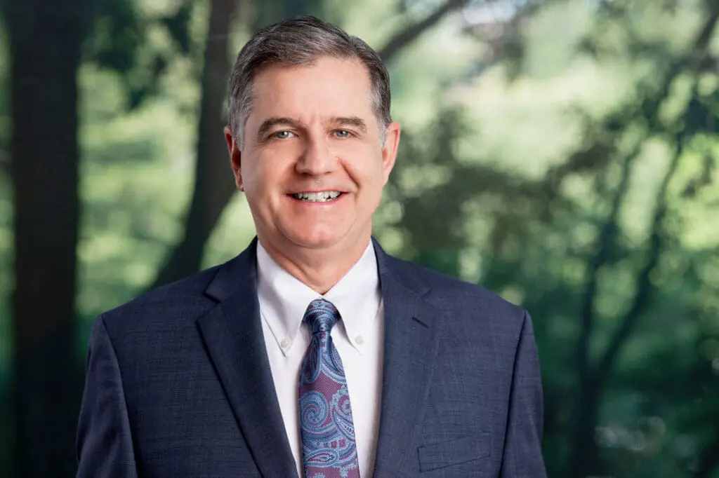 Smiling attorney in suit and tie outdoors, ready to help with your personal injury case