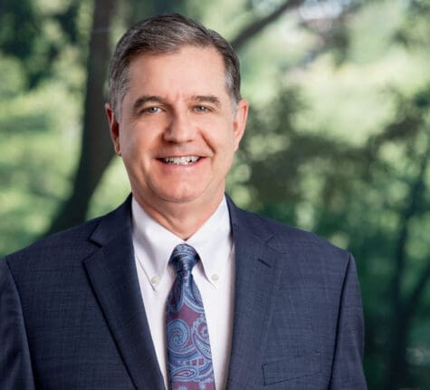 Smiling attorney in suit and tie outdoors, ready to help with your personal injury case