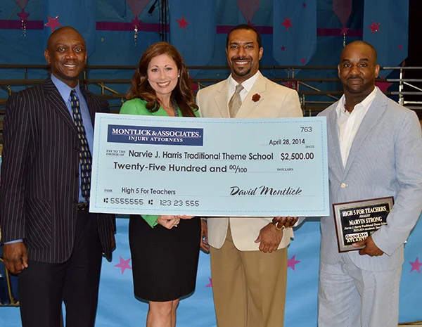 Left to right: Michael Thurmond, DeKalb County School District - Superintendent; Melinda Jeffress, Montlick & Associates - Director of Community Programs; Dr. Sean R. Tartt, Narvie J. Harris Traditional Theme School - Principal; Marvin Strong, Narvie J. Harris Traditional Theme School - Music Teacher