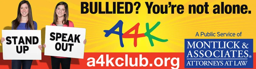 Anti-bullying campaign image with two young women holding "Stand up" and "Speak out" signs, promoted by A4K and an injury law firm.