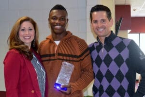 Attorneys Alicia, Marcus and John smiling while holding legal documents, ready to assist clients.