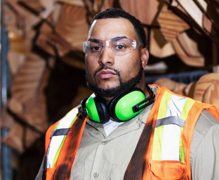 Construction worker wearing safety gear, looking serious. Workplace injury concept for legal website.