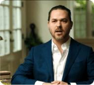 Confident attorney in blue suit looks directly at camera, conveying trust and professionalism.