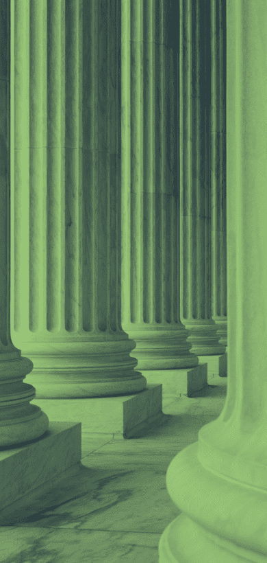 Green marble columns of a government building, symbolizing strength and justice in a legal context.