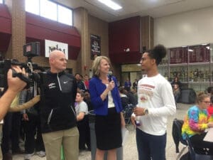 Basketball coach and student athletes interviewed at school, discussing achieving goals responsibly.