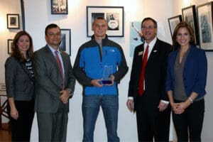 Attorney team with award-winning student athlete in office, discussing personal injury case