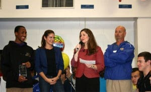 Injury attorney discusses case with diverse group of clients in office, friendly consultation