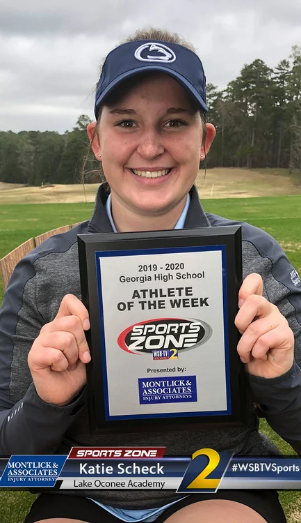The image shows a smiling young woman wearing a blue Penn State baseball cap holding an "Athlete of the Week" certificate from Georgia High School Sports Zone presented by Montlick & Associates Injury Attorneys. She appears to be standing on a golf course or athletic field.