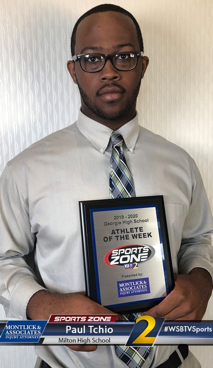 Image of a young man holding a "Milton High School Athlete of the Week" plaque from Sports Zone, an athletic equipment retailer.