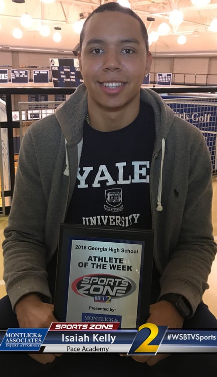 Yale University student athlete wearing Sports Zone jersey smiles at awards event at his high school