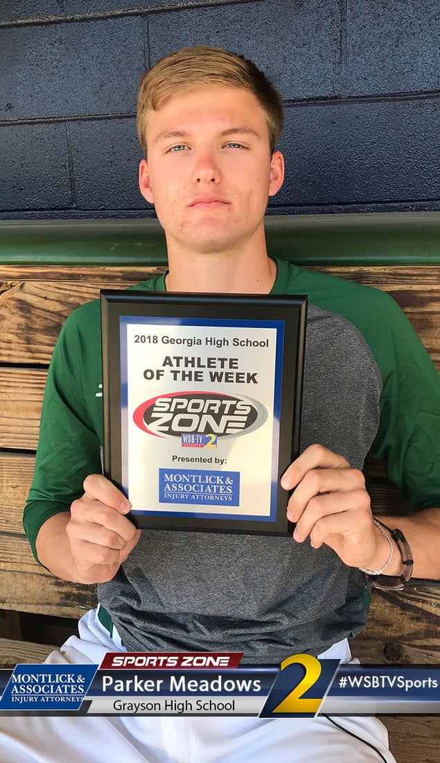 High school athlete holding Sports Zone Athlete of the Week award sponsored by injury attorney firm.