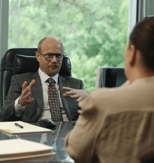 Attorney consults with client in office, discussing legal advice and representation options