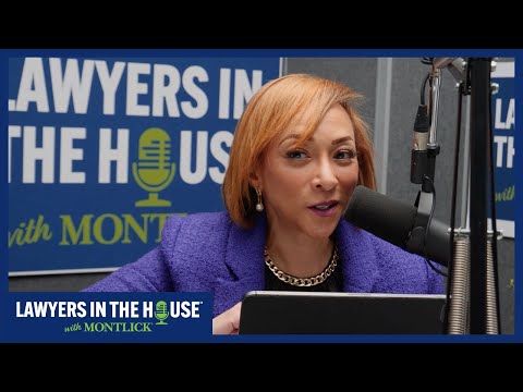 Brightly smiling woman with short blonde hair speaking into a microphone at a "Lawyers in the House with Montgomery" event.