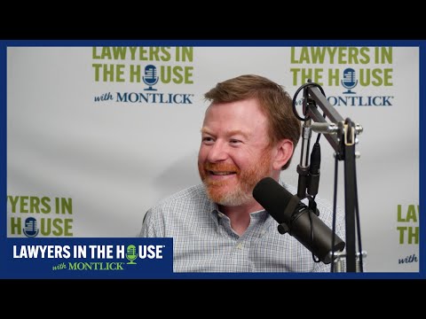 Smiling Georgia injury attorney with microphone on Lawyers in the House podcast, representing injured clients