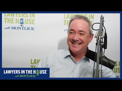 Smiling injury attorney promoting Georgia legal podcast "Lawyers in the House"