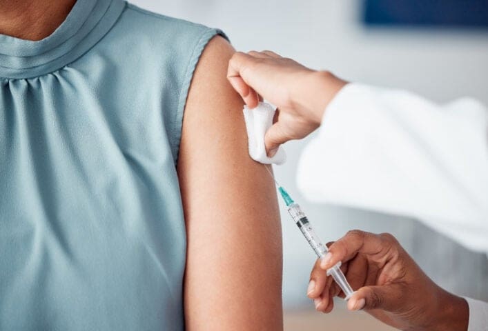 Person receiving pharmaceutical injection, representing the Depo-Provera lawsuit and potential class action for those affected by side effects of the Depo-Provera shot