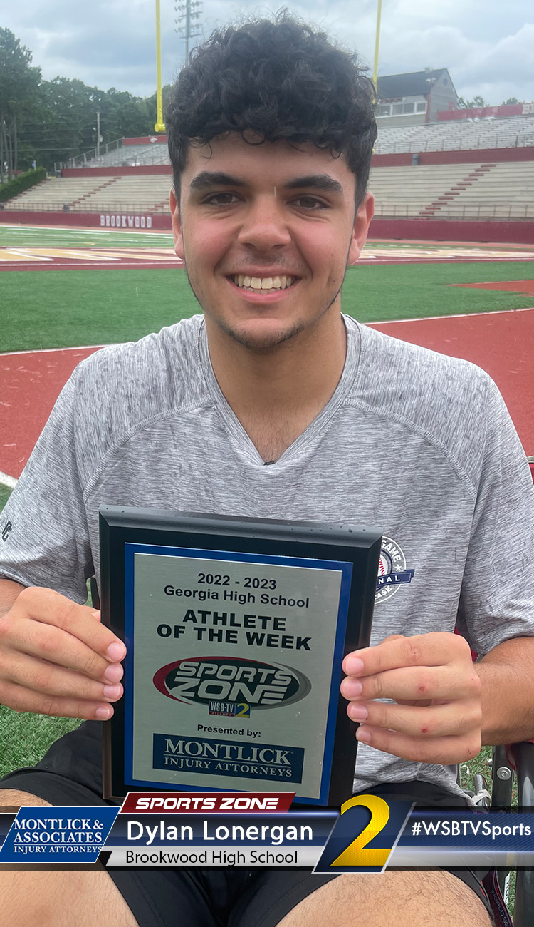 Smiling high school athlete holding Sports Zone Athlete of the Week award