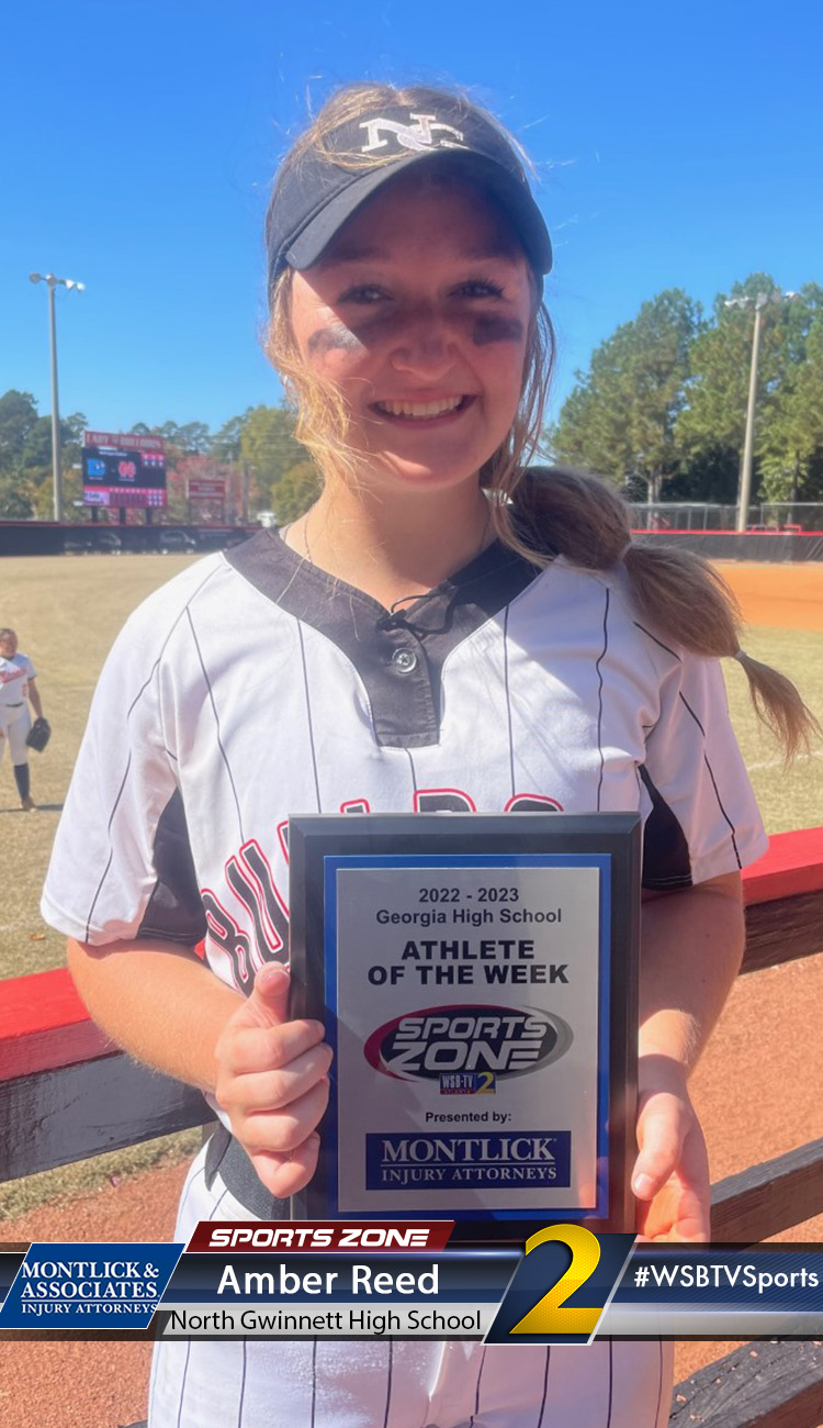 Smiling high school athlete holding Sports Zone Athlete of the Week award