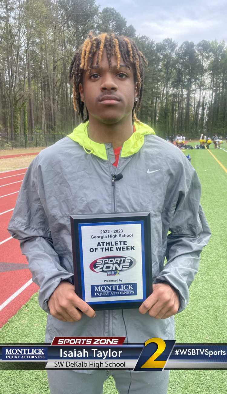 Smiling high school athlete holding Sports Zone Athlete of the Week award