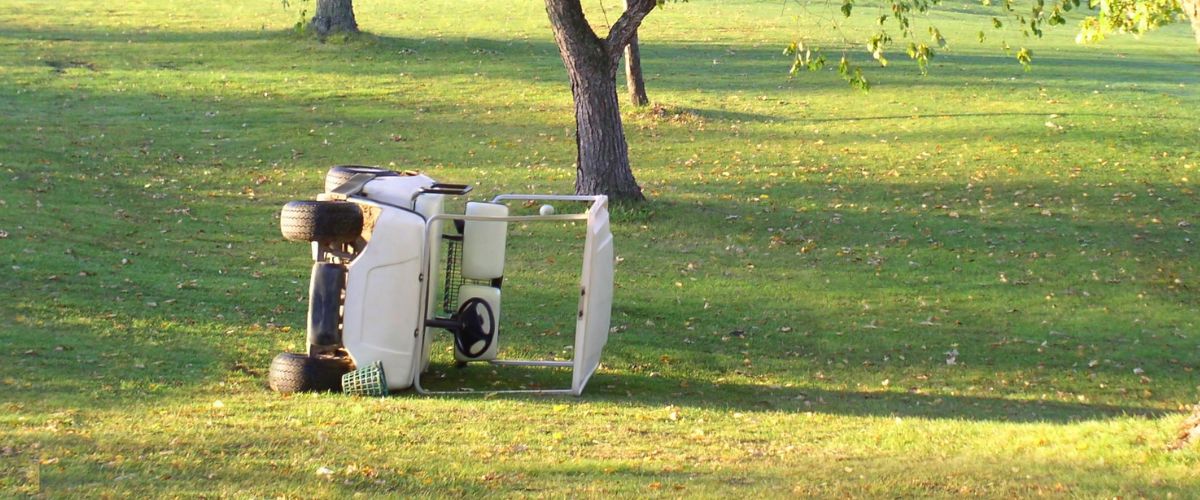 a golf cart on its side after a golf cart accident